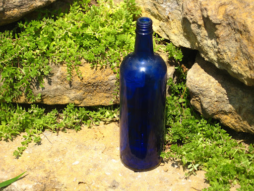 Assorted cobalt blue wine bottles available for rent from www.momentarilyyours.com, $1 each.