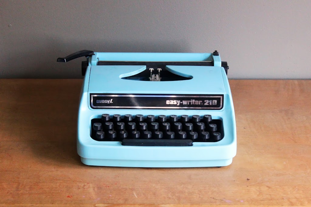 Blue retro typewriter available for rent from www.momentarilyyours.com, $10.