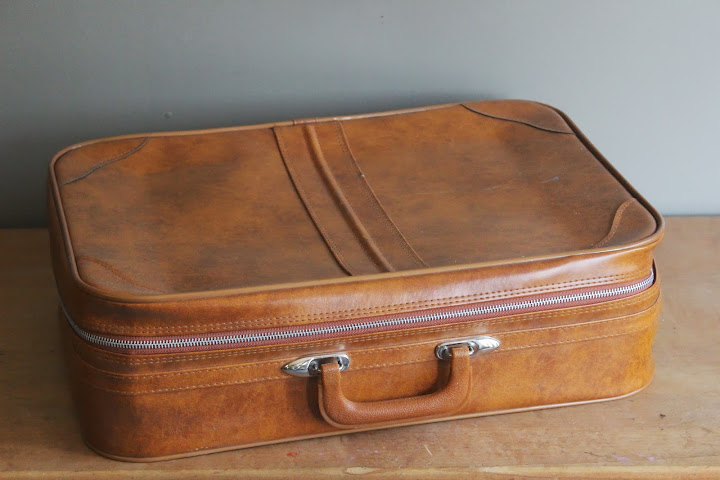 Large tan suitcase available for rent from www.momentarilyyours.com, $5.