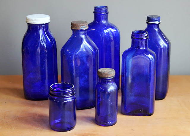 Cobalt blue medicine bottles available for rent from www.momentarilyyours.com, $1.25 each.