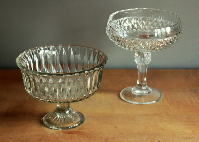 Assorted large clear pedestal bowls available for rent from www.momentarilyyours.com | Kansas City Vintage Rentals